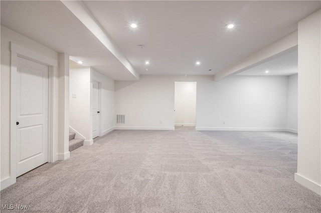 basement featuring light carpet