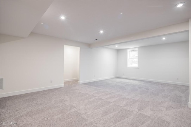 basement featuring light colored carpet