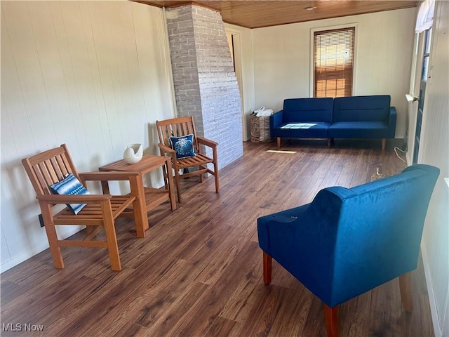 sitting room featuring wood ceiling, wood walls, and dark wood-type flooring