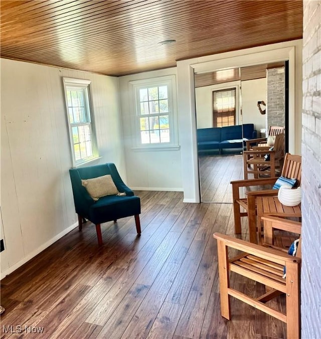 sitting room with wooden ceiling and dark wood-type flooring