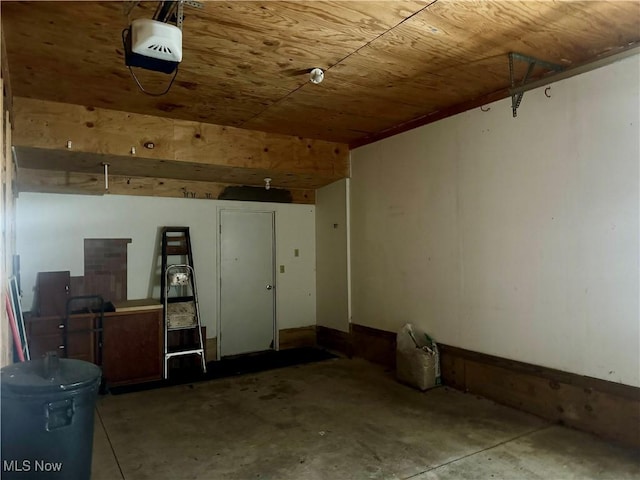 garage with a garage door opener and wooden ceiling