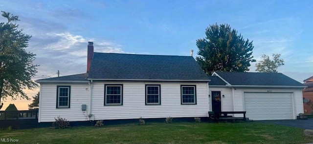 view of front of house featuring a garage and a yard