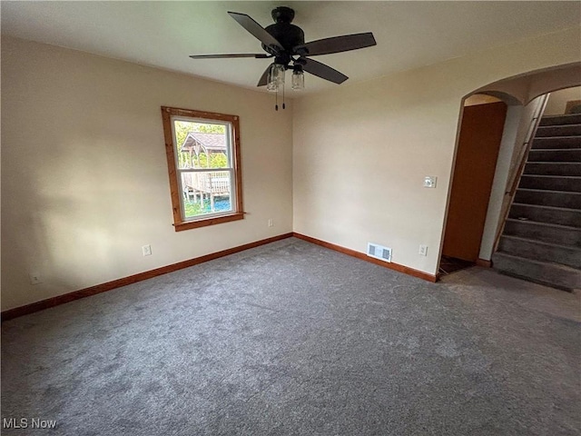 7836 Oak St, Masury, OH 44438 - carpeted spare room with arched walkways, stairway, visible vents, and baseboards