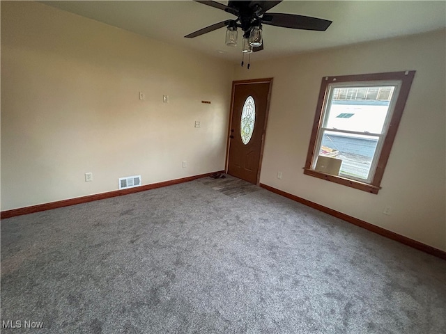 entryway with ceiling fan and carpet floors