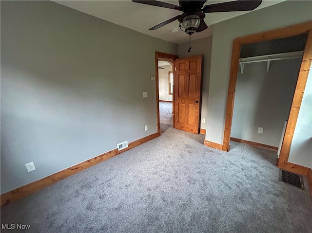 unfurnished bedroom featuring ceiling fan, a closet, and carpet flooring