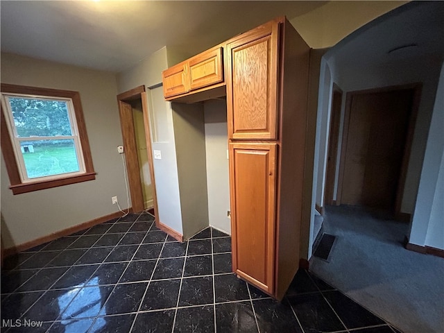 kitchen featuring dark tile patterned floors