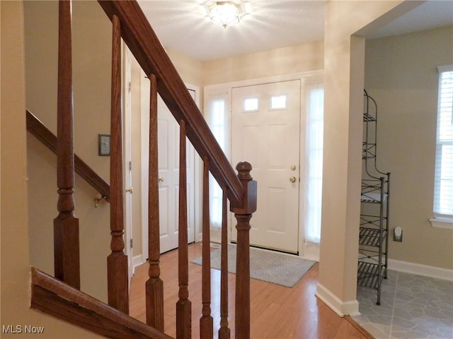 foyer entrance with plenty of natural light and light hardwood / wood-style floors