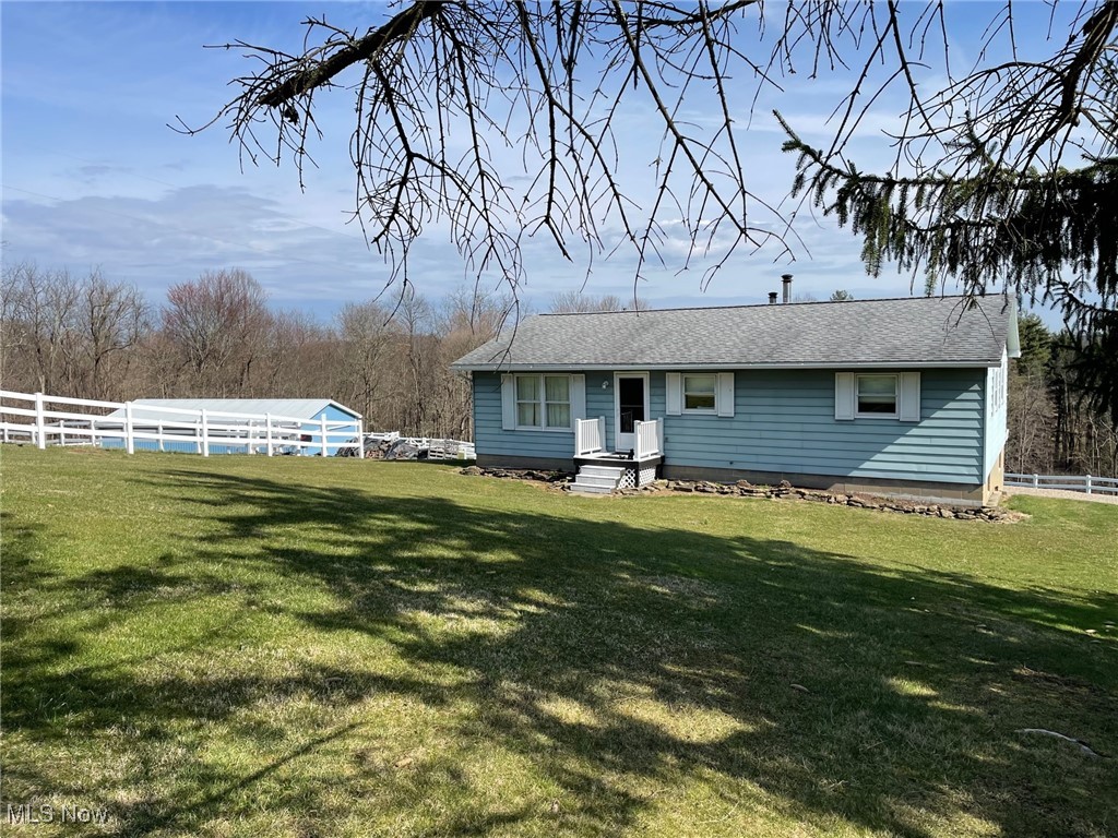 back of property featuring a lawn