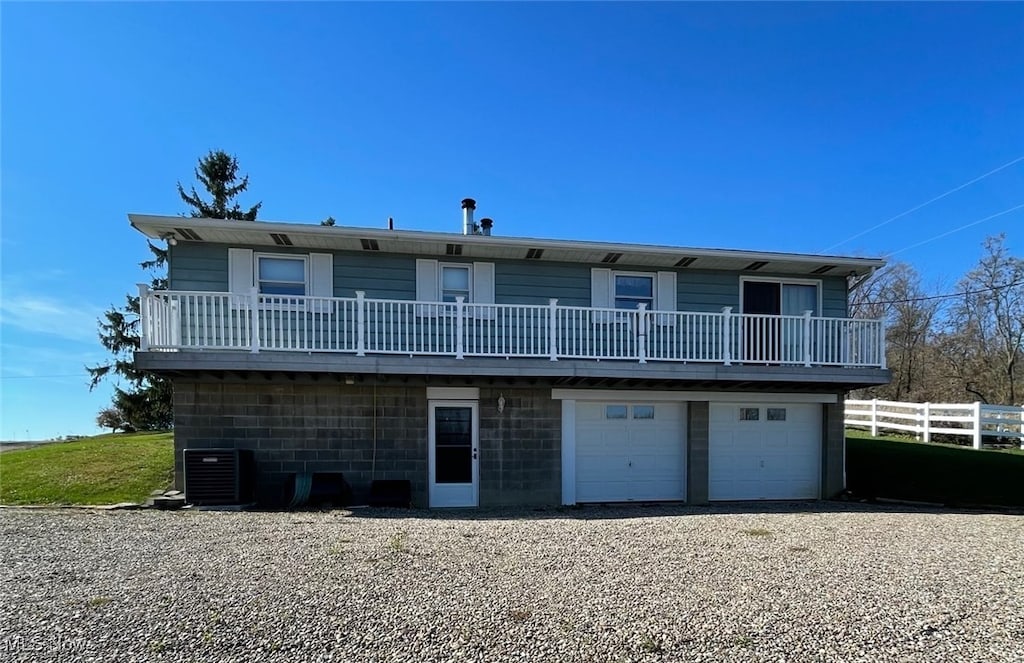 exterior space featuring cooling unit and a garage