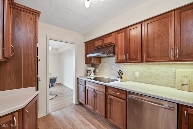 kitchen featuring black electric stovetop, under cabinet range hood, light wood-type flooring, light countertops, and stainless steel dishwasher