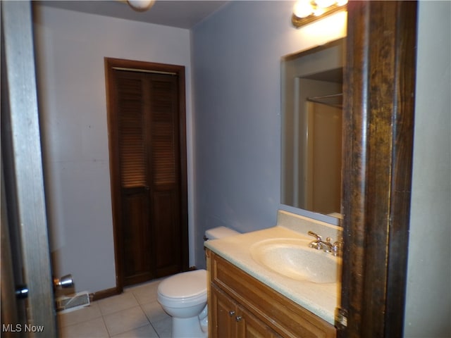 bathroom with vanity, tile patterned floors, and toilet