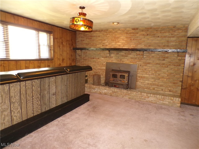 bar with a wood stove, carpet floors, and wooden walls