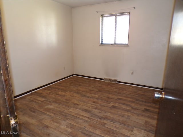 empty room featuring dark hardwood / wood-style flooring