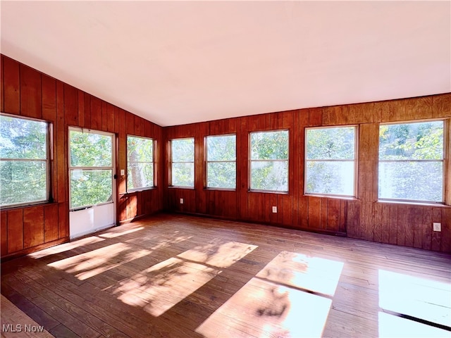 unfurnished sunroom with vaulted ceiling and a healthy amount of sunlight