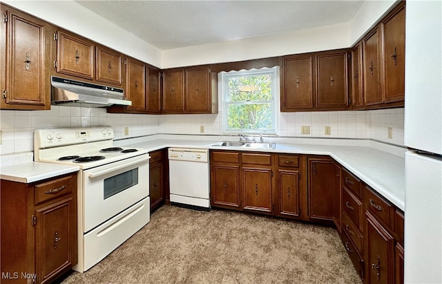 kitchen with light colored carpet, backsplash, sink, and white appliances