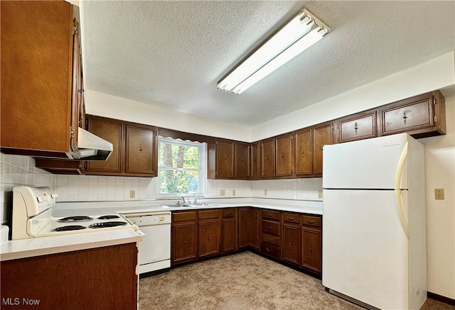 kitchen with a textured ceiling, sink, light colored carpet, decorative backsplash, and white appliances