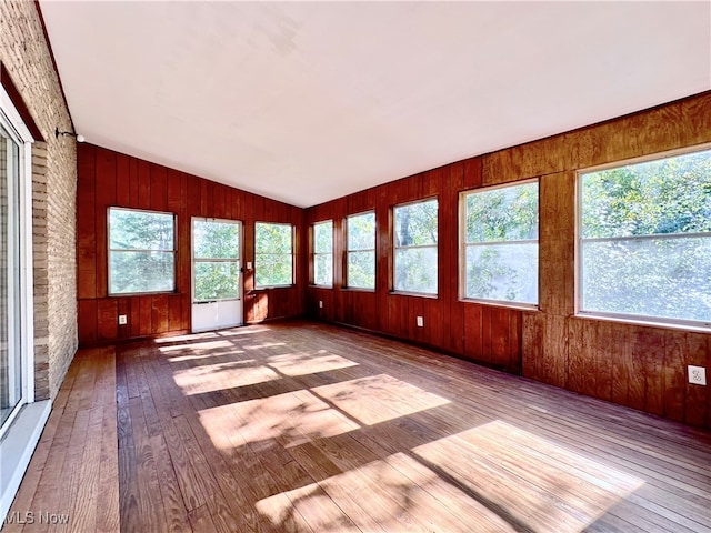 unfurnished sunroom with a healthy amount of sunlight and vaulted ceiling