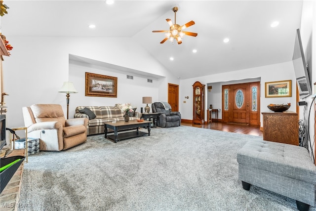 living room with ceiling fan, high vaulted ceiling, and wood-type flooring