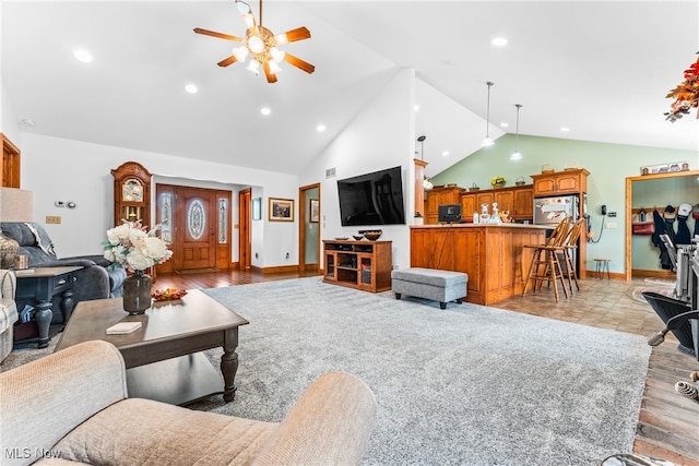 living room featuring ceiling fan, light hardwood / wood-style flooring, and lofted ceiling