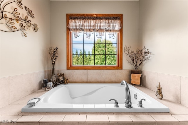 bathroom with a relaxing tiled tub