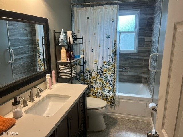 full bathroom with vanity, shower / tub combo, and toilet