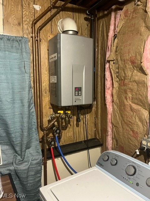 utility room with washer / clothes dryer and tankless water heater