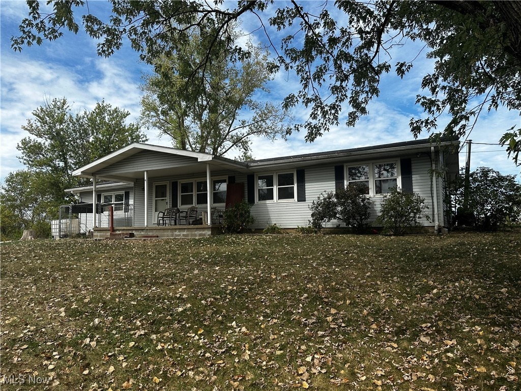 ranch-style house featuring a front yard and a porch