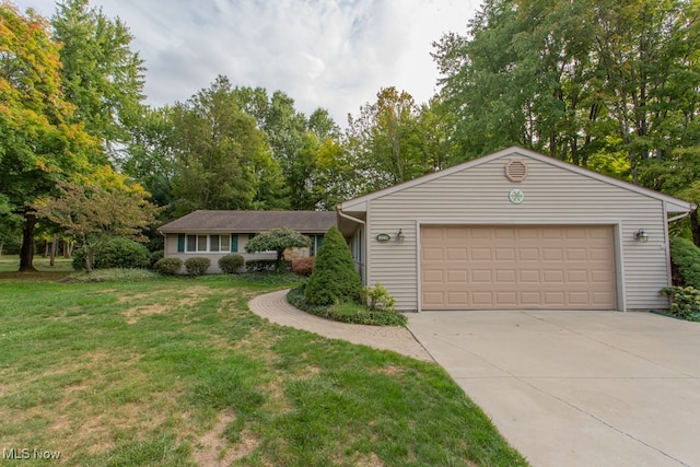 ranch-style home with a front lawn and a garage