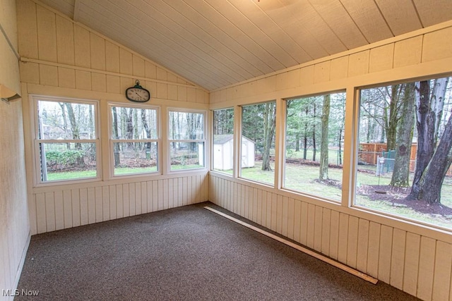 unfurnished sunroom featuring lofted ceiling and wooden ceiling