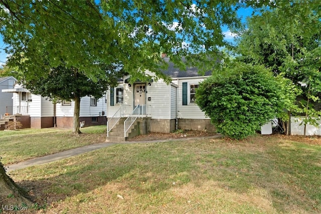 view of property hidden behind natural elements featuring a front yard