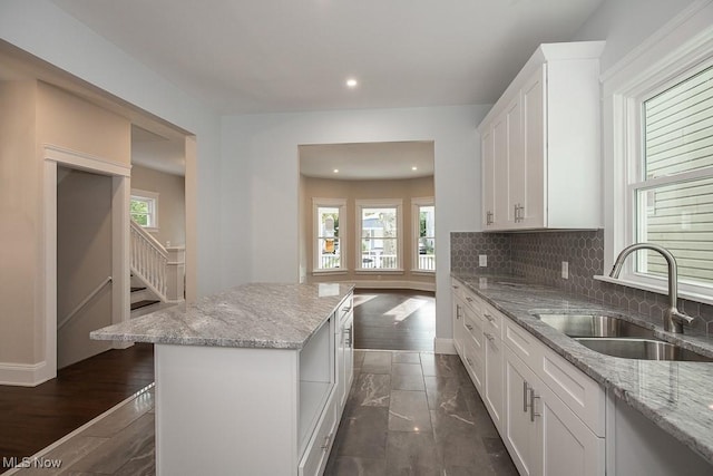 1360 E 114th St, Cleveland, OH 44106 - kitchen featuring a sink, tasteful backsplash, a kitchen island, and a wealth of natural light