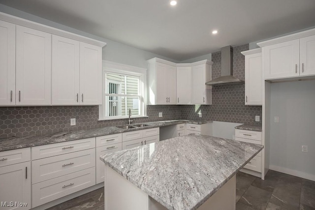1360 E 114th St, Cleveland, OH 44106 - kitchen with wall chimney range hood, light stone countertops, tasteful backsplash, and a sink