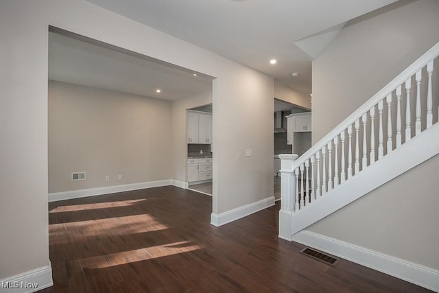 1360 E 114th St, Cleveland, OH 44106 - unfurnished living room with wood finished floors, baseboards, visible vents, and recessed lighting
