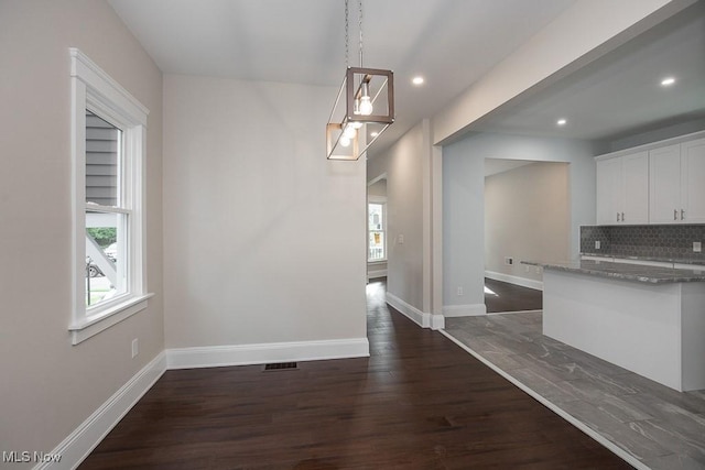 1360 E 114th St, Cleveland, OH 44106 - unfurnished dining area with baseboards, dark wood finished floors, visible vents, and recessed lighting