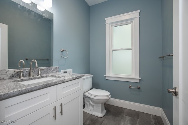 bathroom featuring hardwood / wood-style floors, vanity, and toilet