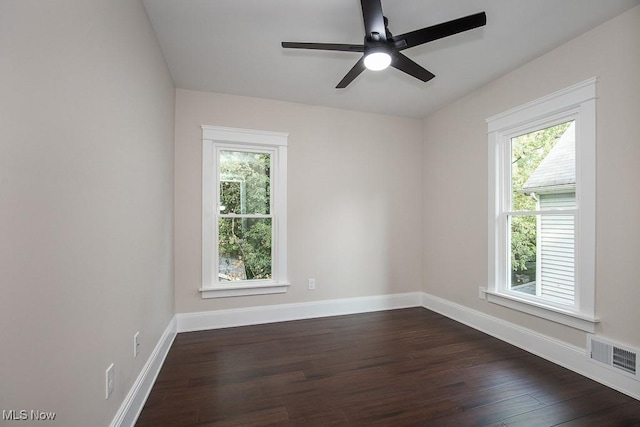 1360 E 114th St, Cleveland, OH 44106 - empty room with a wealth of natural light, visible vents, a ceiling fan, and dark wood-style floors