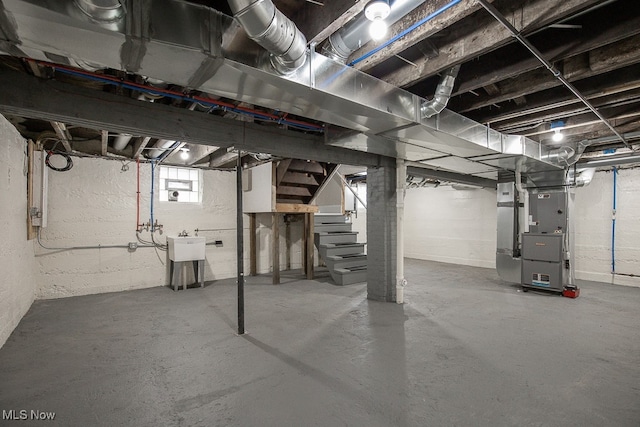 basement with heating unit and sink