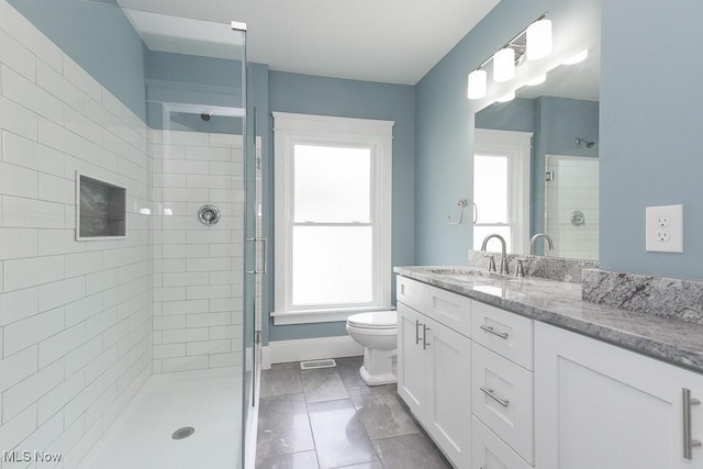 1360 E 114th St, Cleveland, OH 44106 - bathroom with visible vents, baseboards, toilet, a tile shower, and vanity