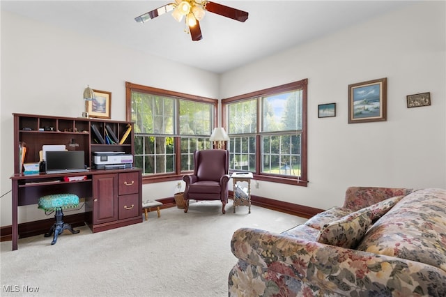 office area with a wealth of natural light, ceiling fan, and light colored carpet