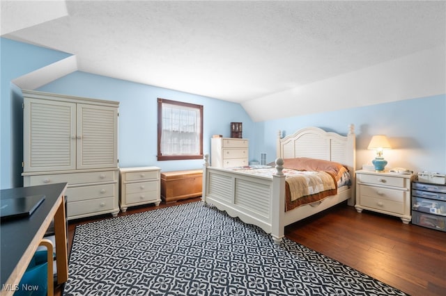 bedroom with vaulted ceiling, a textured ceiling, and dark hardwood / wood-style flooring