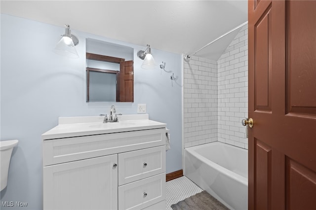 full bathroom featuring tile patterned flooring, lofted ceiling, tiled shower / bath, vanity, and toilet