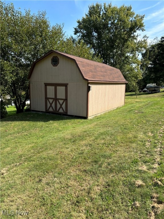 view of outdoor structure featuring a lawn