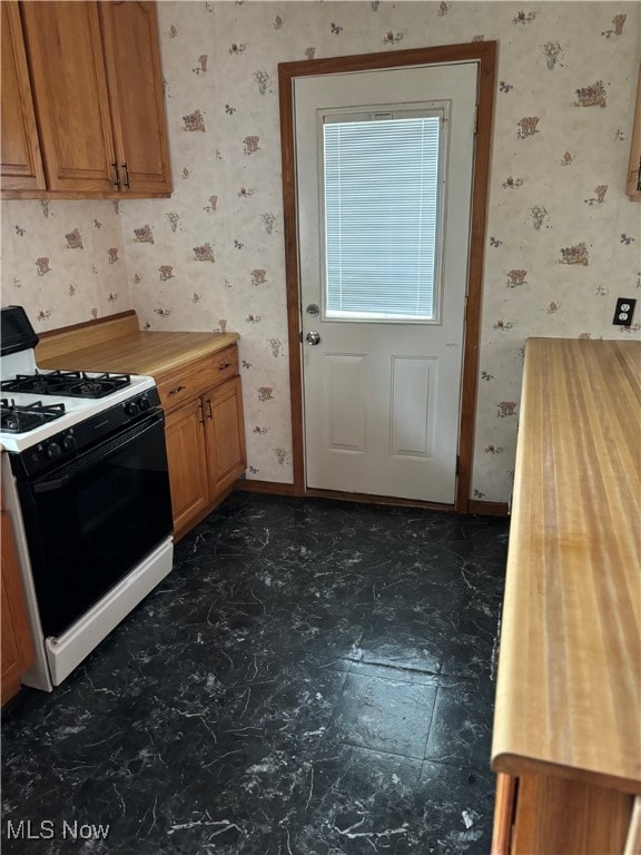 kitchen with white range with gas stovetop