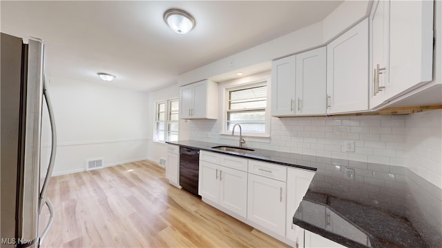 kitchen with stainless steel fridge, light hardwood / wood-style floors, white cabinetry, black dishwasher, and sink