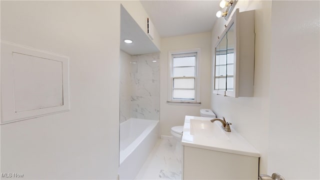 full bathroom featuring tiled shower / bath combo, vanity, and toilet