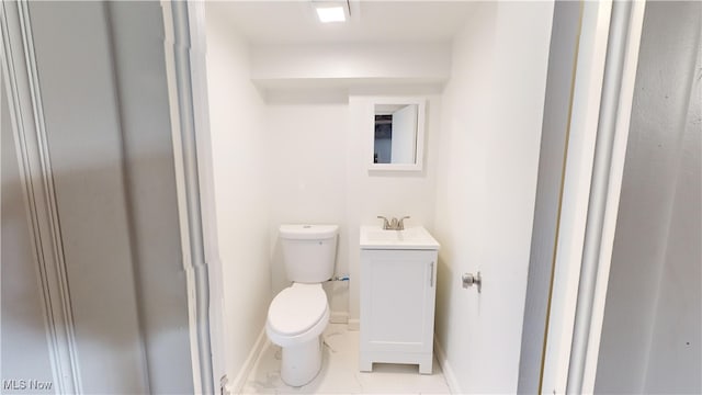 bathroom with vanity, tile patterned flooring, and toilet