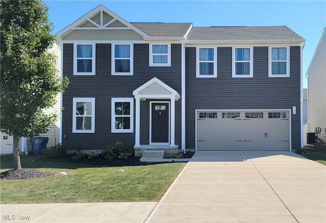 view of front of house featuring a garage, central AC, and a front yard