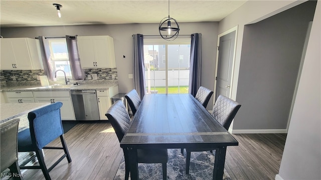 dining space featuring a textured ceiling, dark hardwood / wood-style floors, and sink