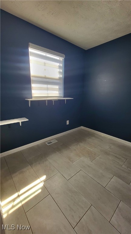 empty room with a textured ceiling