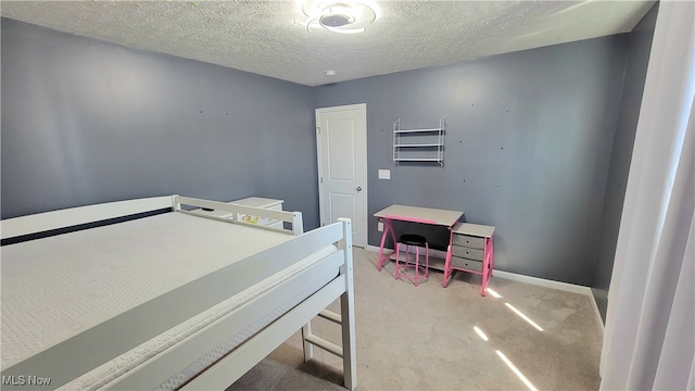 carpeted bedroom with a textured ceiling